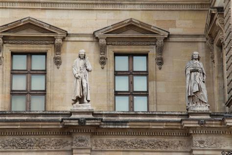 Statues Of Voltaire And Bossuet On Facade Of Louvre Palace Paris France