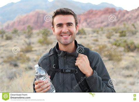 Man With Fit Body Drinking Water Resting After Running