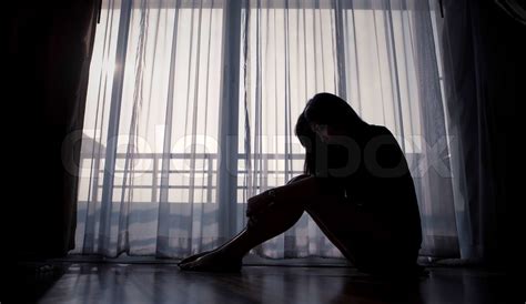 Sad Woman Sitting Alone Near Window Stock Image Colourbox