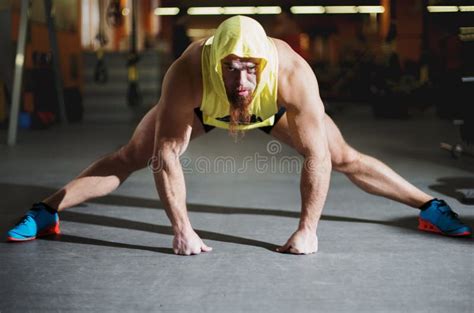 Portrait Of A Fitness Man Doing Stretching Exercises At Gym Stock Photo