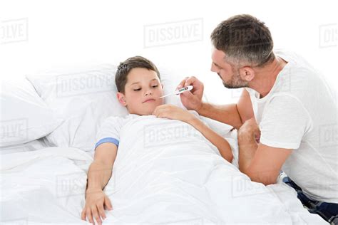 Father Measuring Body Temperature To Sick Son Isolated On White