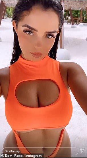 Demi Rose Flaunts Her Ample Cleavage In A Cut Out Neon Orange Swimsuit