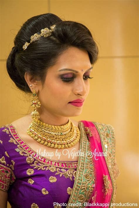 What a beautiful large low bun covered with jasmine. Indian bride Akshaya wears gorgeous pink and purple bridal ...