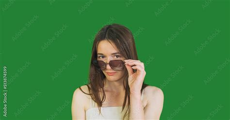 Young Woman Lowers Her Big Sunglasses Down Her Nose Looks Up And Puts