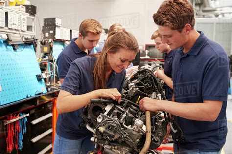 Apprentice Car Mechanics Working On An Engine Stock Photo Dissolve