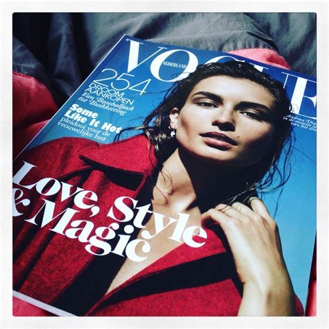 a magazine with the cover of a woman s face on top of her jacket