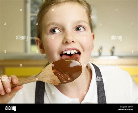 A Girl Licks A Spoon Stock Photo Alamy