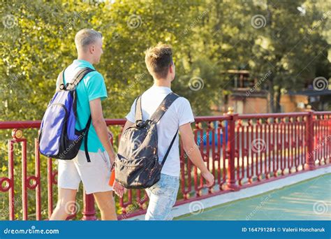 Lifestyle Of Young Males Teenagers With Backpacks Walking Their Backs