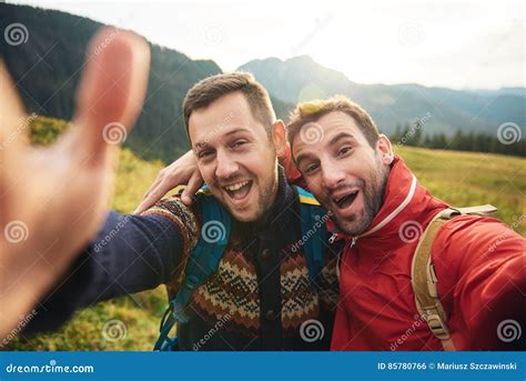 Smiling Hikers Taking A Selfie While Trekking In The Wilderness Stock