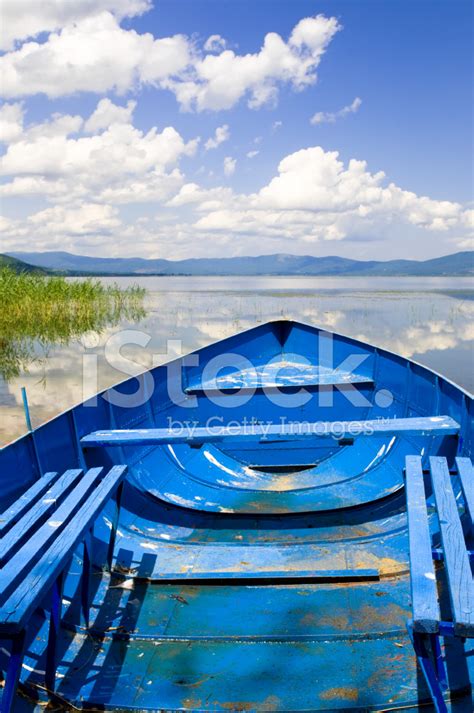 Sailing With Old Fishing Boat On Beautiful Mountain Lake Stock Photo