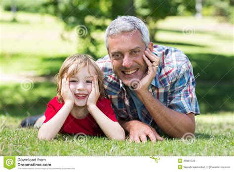 Happy Father Lying On The Grass With His Son Stock Photo Image Of