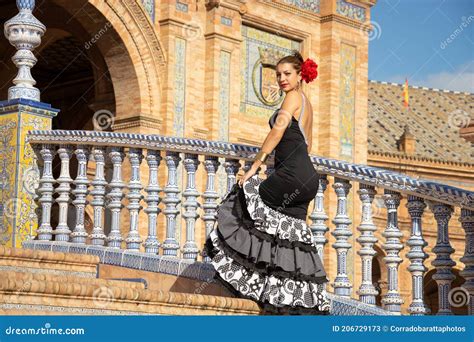 The Beautiful Woman In The Flamenco Dress On The Stairs Of The Plaza De