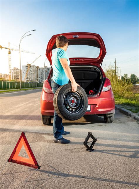Man Taking Spare Wheel Out Of Trunk Stock Image Image Of Brake