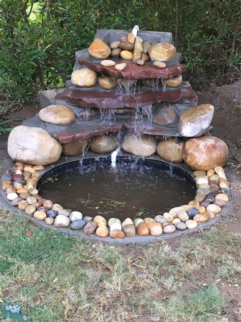 A Fountain Made Out Of Rocks And Water
