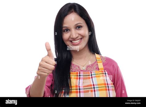 Happy Young Indian Woman Wearing Kitchen Apron And Showing Thumbs Up