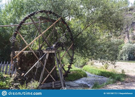 Old Working Watermill Wheel With Falling Water Stock Photo