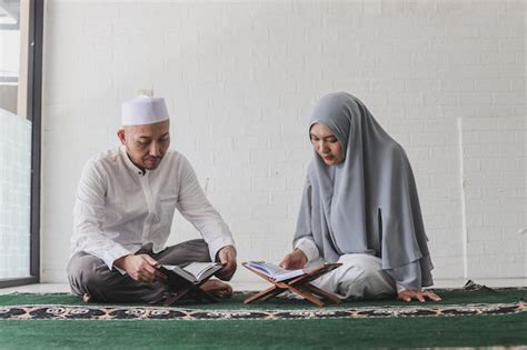 Premium Photo Asian Muslim Man Teaching His Wife Reading Koran Or Quran During Ramadan Month