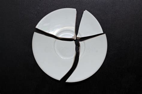 Broken Plate On A Black Background A Try To Restore The Whole From The