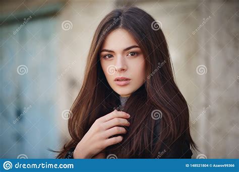 Street Portrait Of A Beautiful Young Brunette Girl In A