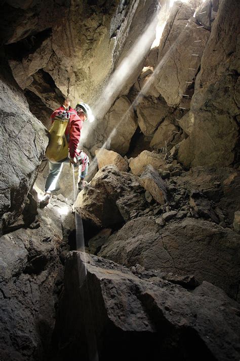 A Cave Explorer Descends Photograph By Robbie Shone Fine Art America