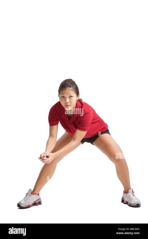 Young Woman Bending Down Waiting For Volleyball Stock Photo Alamy