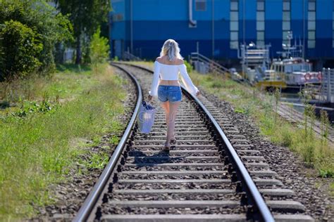 Back View Of A Blond Woman On Train Tracks Stock Photo Image Of Train