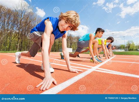 Teenage Athletes Preparing To Start Running Stock Photo Image Of