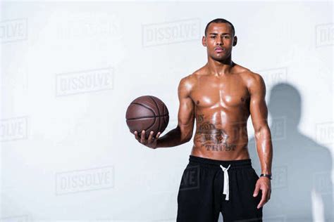 Athletic Shirtless African American Man With Basketball Ball Looking At Camera On Grey Stock