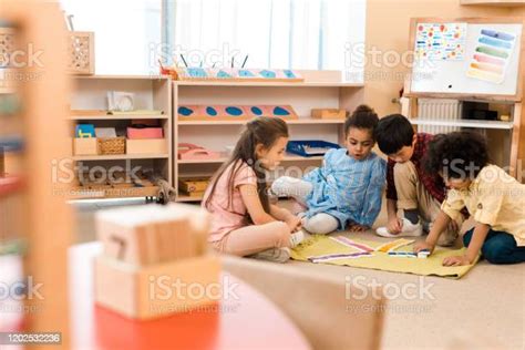 Selective Focus Of Children Playing Game On Floor In Montessori School
