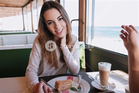 Woman Sitting By The Table With Food On Date In Cafe Near The Sea