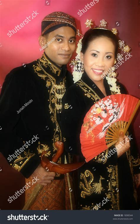 A Malay Bride And Groom In Their Traditional Javanese Costume On The