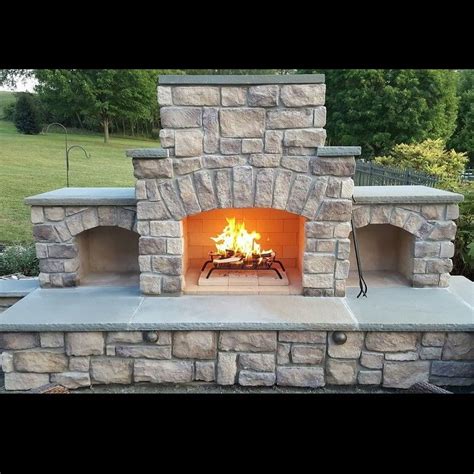 An Outdoor Fireplace Is Shown In The Middle Of A Yard