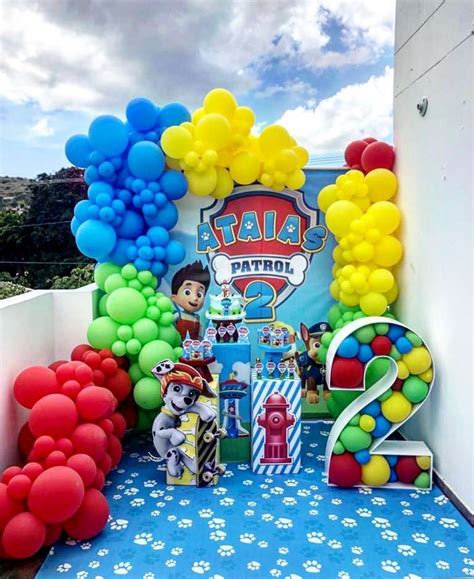 An Outdoor Birthday Party With Balloons And Paw Patrol Decorations On