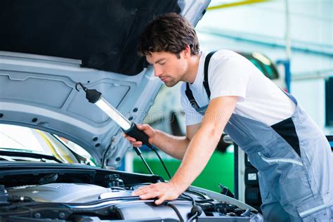Mechanic With Diagnostic Tool In Car Workshop Stock Image Image Of