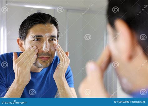 Man Washing Face With Facial Cleanser Face Wash Soap Looking At Mirror
