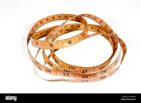 Studio Shot Coiled Vintage Tape Measure Depicting Inches And