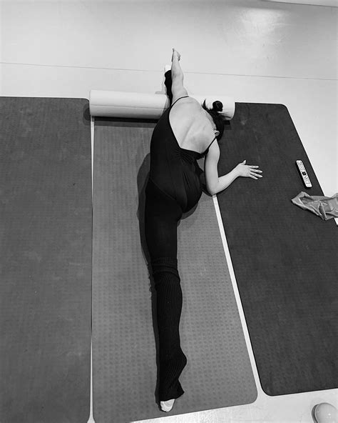 a woman is practicing yoga on her mat