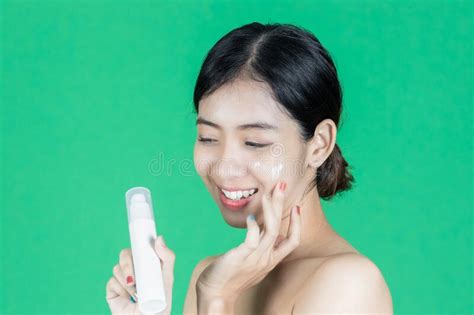 Beauty Healthy Young Asian Woman Holding Container With Face Cream Over