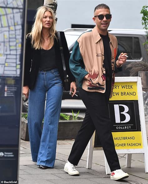 Kate Moss Enjoys A Cigarette And Bumps Into David Furnish In London