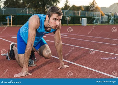 Male Athlete Taking A Start Position For A Sprint Run Stock Image