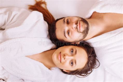 Man And Woman Lying Down On Massage Beds At Luxury Spa And Wellness