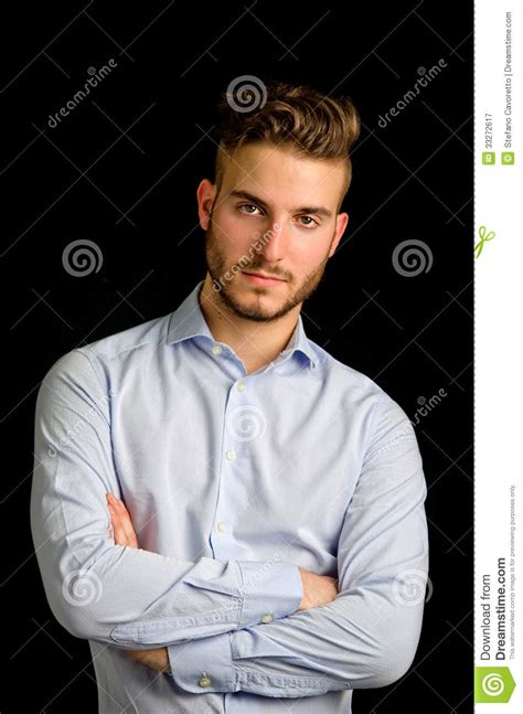Studio Portrait Of Handsome Young Businessman Looking In Camera Stock