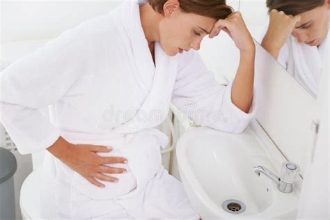 Struggling With Morning Sickness A Pregnant Woman Struggling With Morning Sickness In The