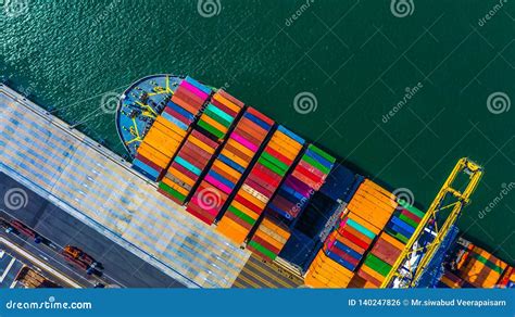 Container Cargo Freight Ship With Working Crane Bridge Discharge At