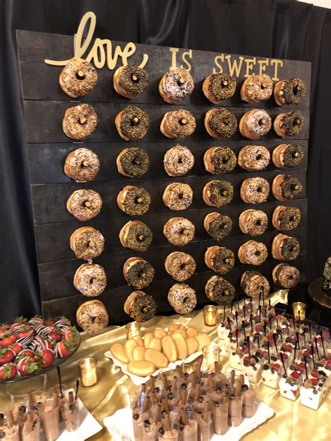 black and gold donut wall and dessert table wedding donuts wedding dessert table donut wall