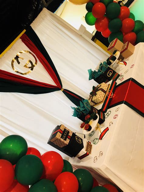The Table Is Decorated With Red White And Green Balloons