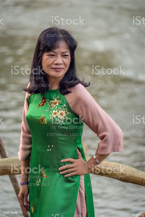 Chinese Woman In A Beautiful Green Dress Posing For A Picture Stock