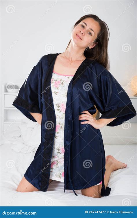 Cute Lady In Black Silk Robe Posing In Bed In Bedroom Stock Image