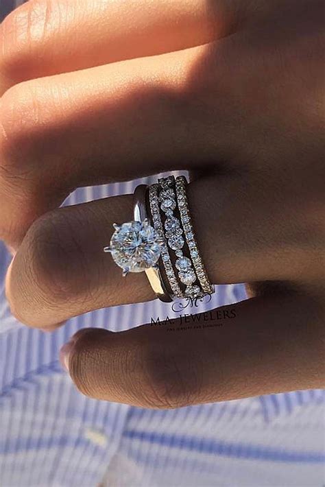 A Woman S Hand With A Ring On It And Two Diamonds In The Middle