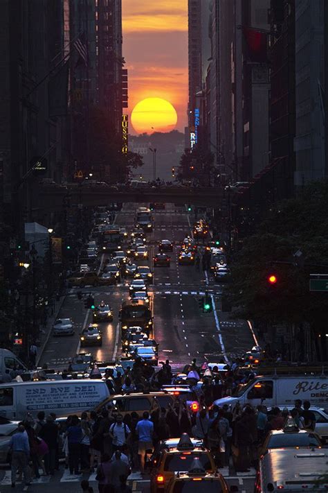 People Take Pictures Of Sunset On 42nd Street During The